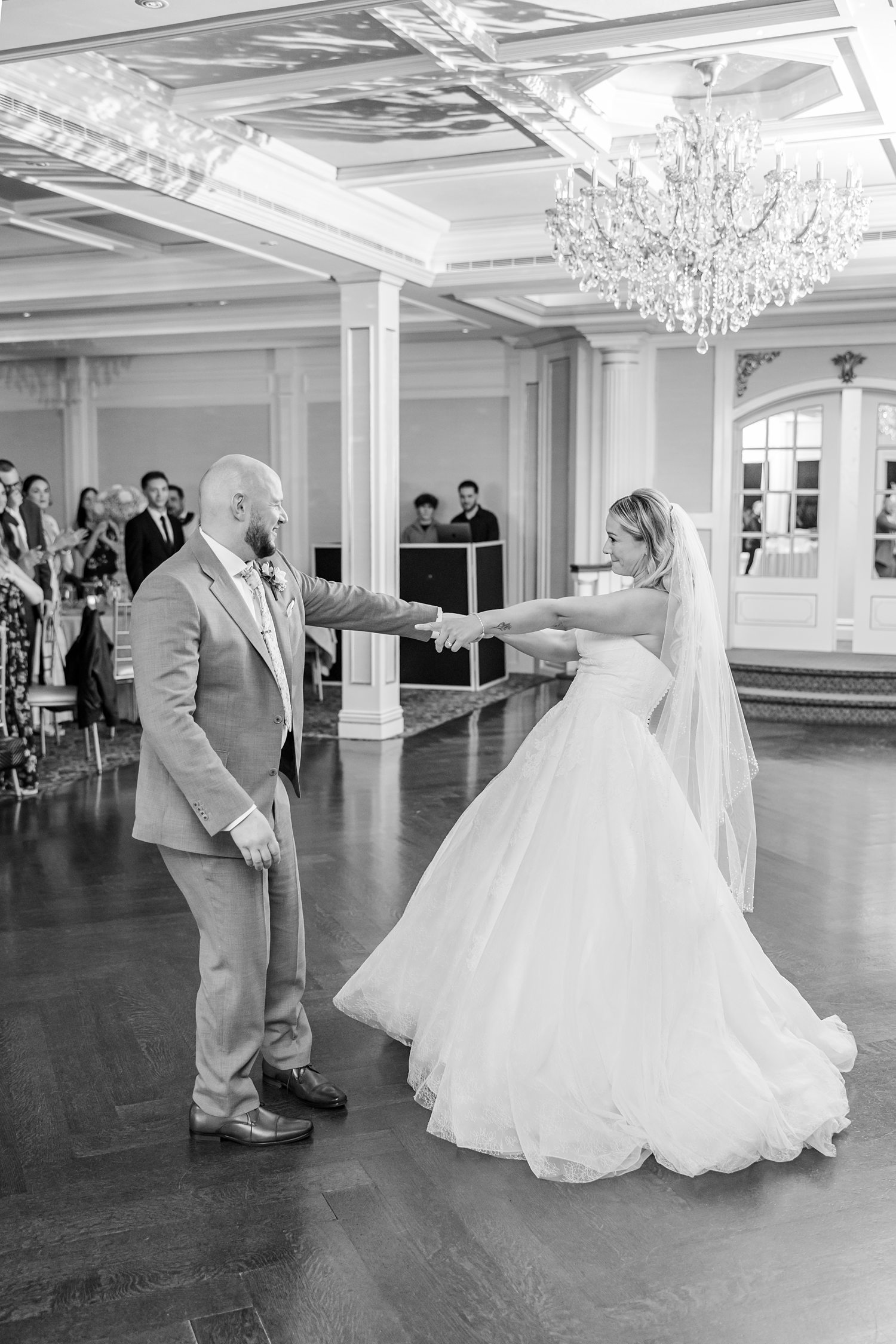 Black and white photo of bride and groom dancing during wedding reception