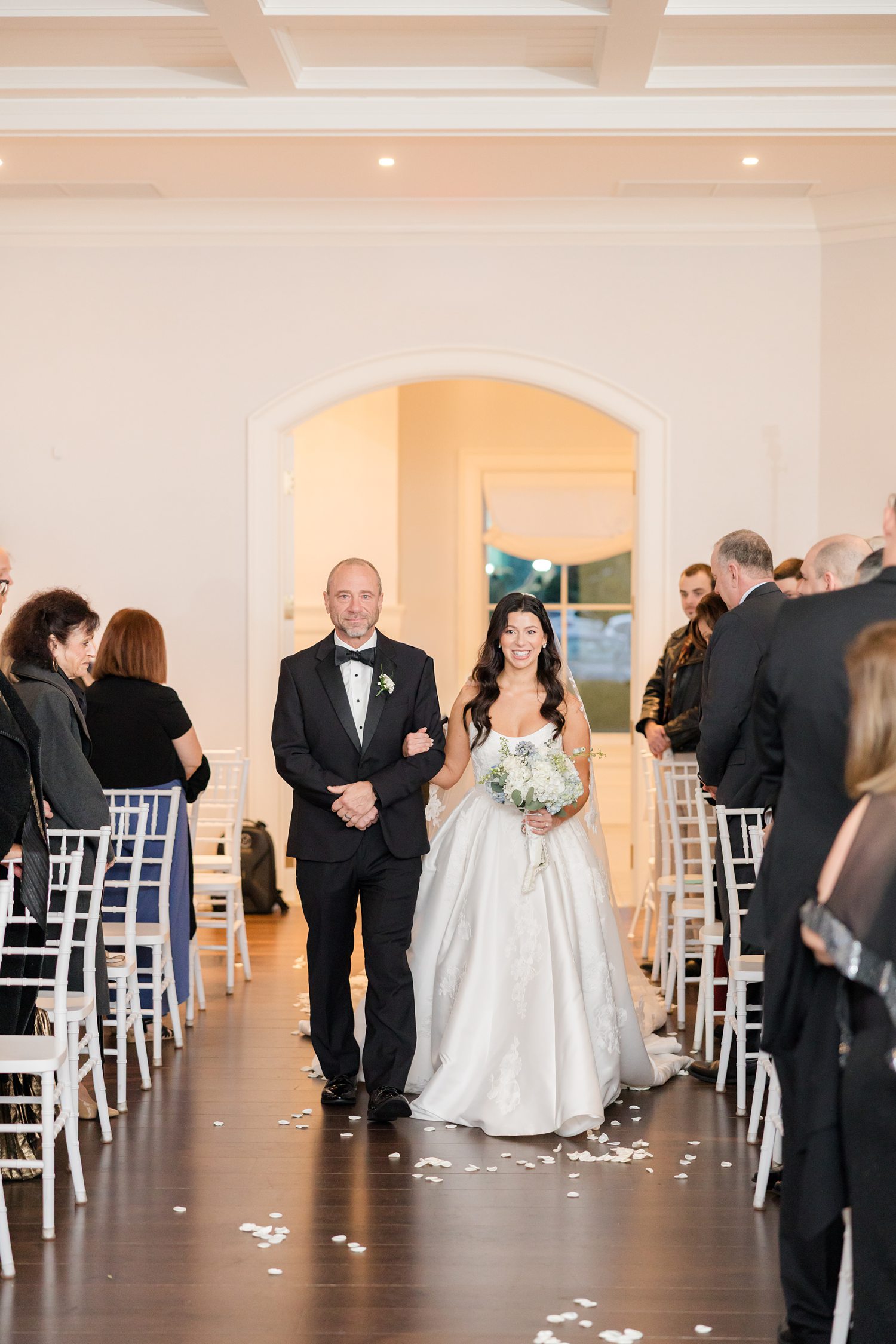 Bride and her father walking down the aisle at Clarks Landing Yacht Club ceremony space 