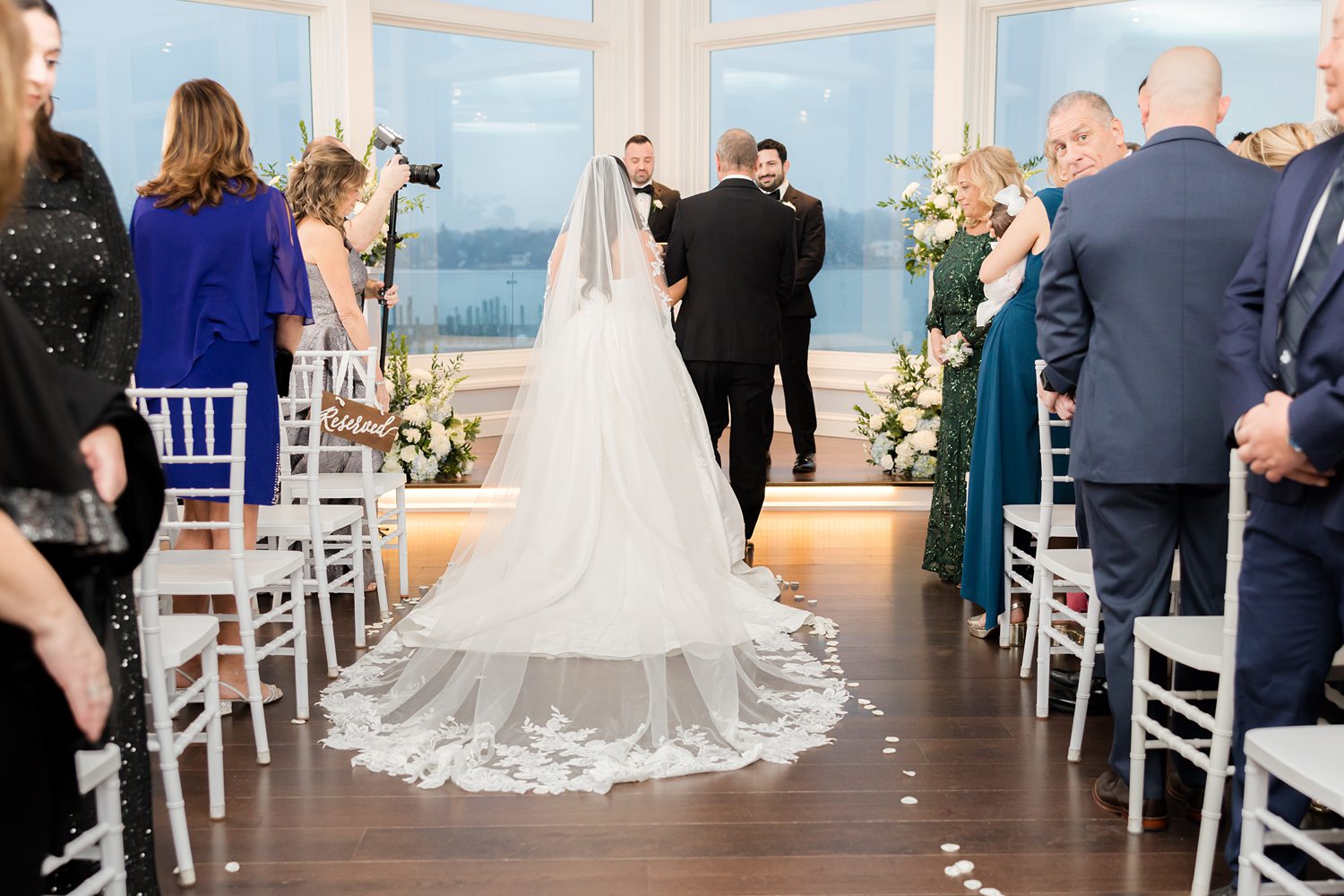 Landscape photo of the bride walking down the aisle with her father 