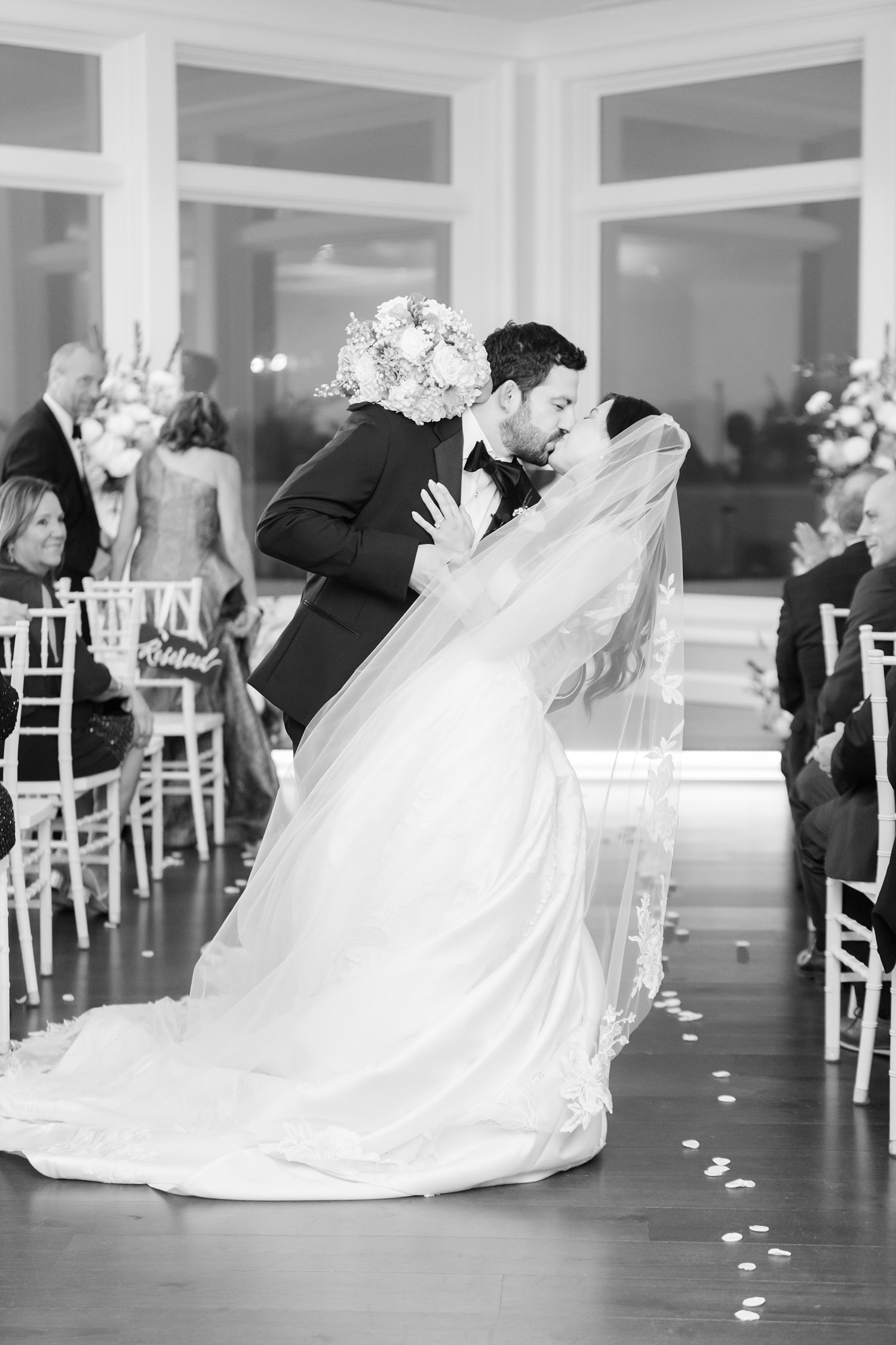 Bride and groom dipkiss at the altar
