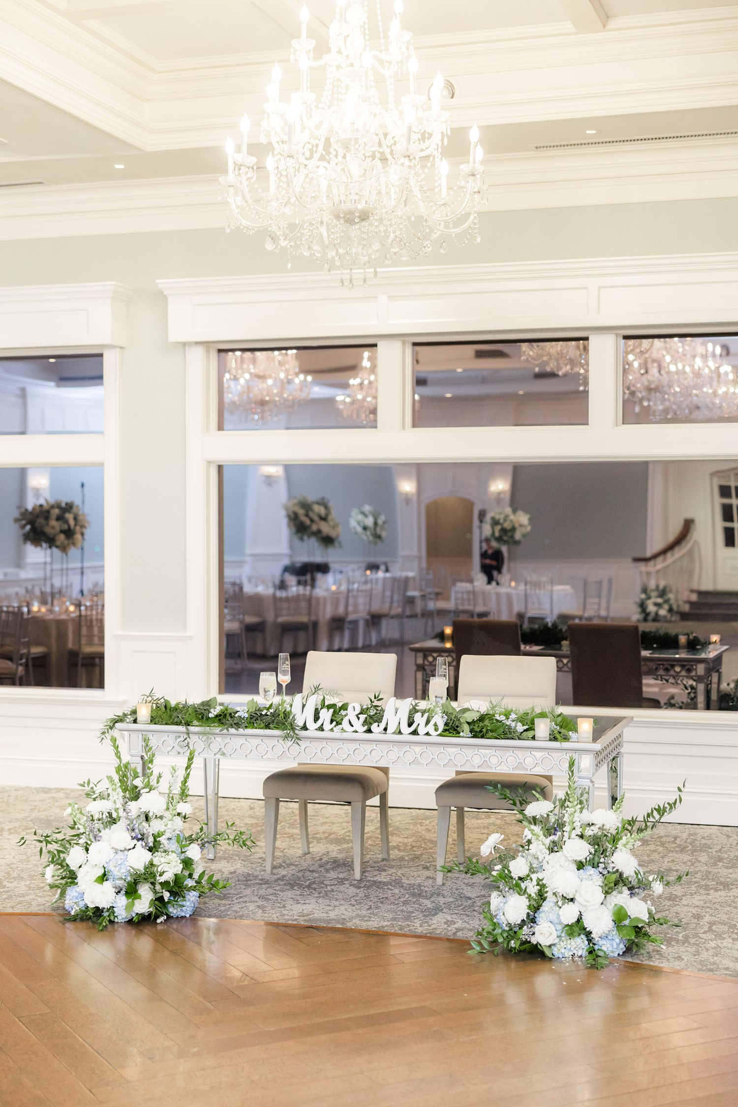 Elegant reception room with white florals and waterfront views