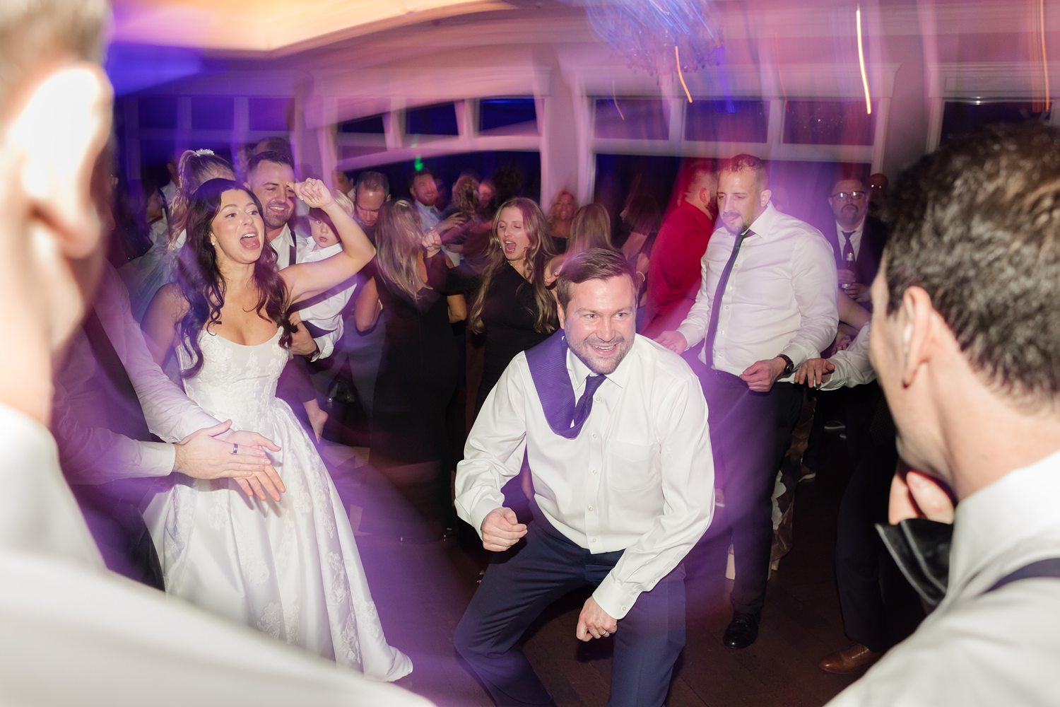 Bride and guests dancing lively at Clarks Landing Yacht Club reception