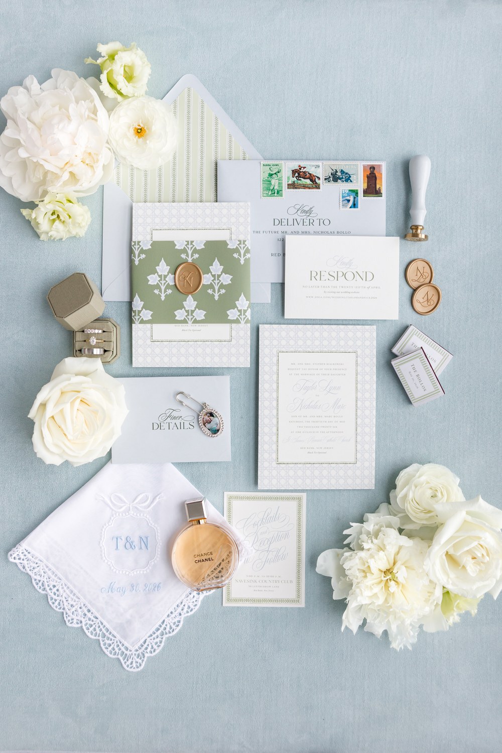 Wedding invitation suite with white roses flat lay