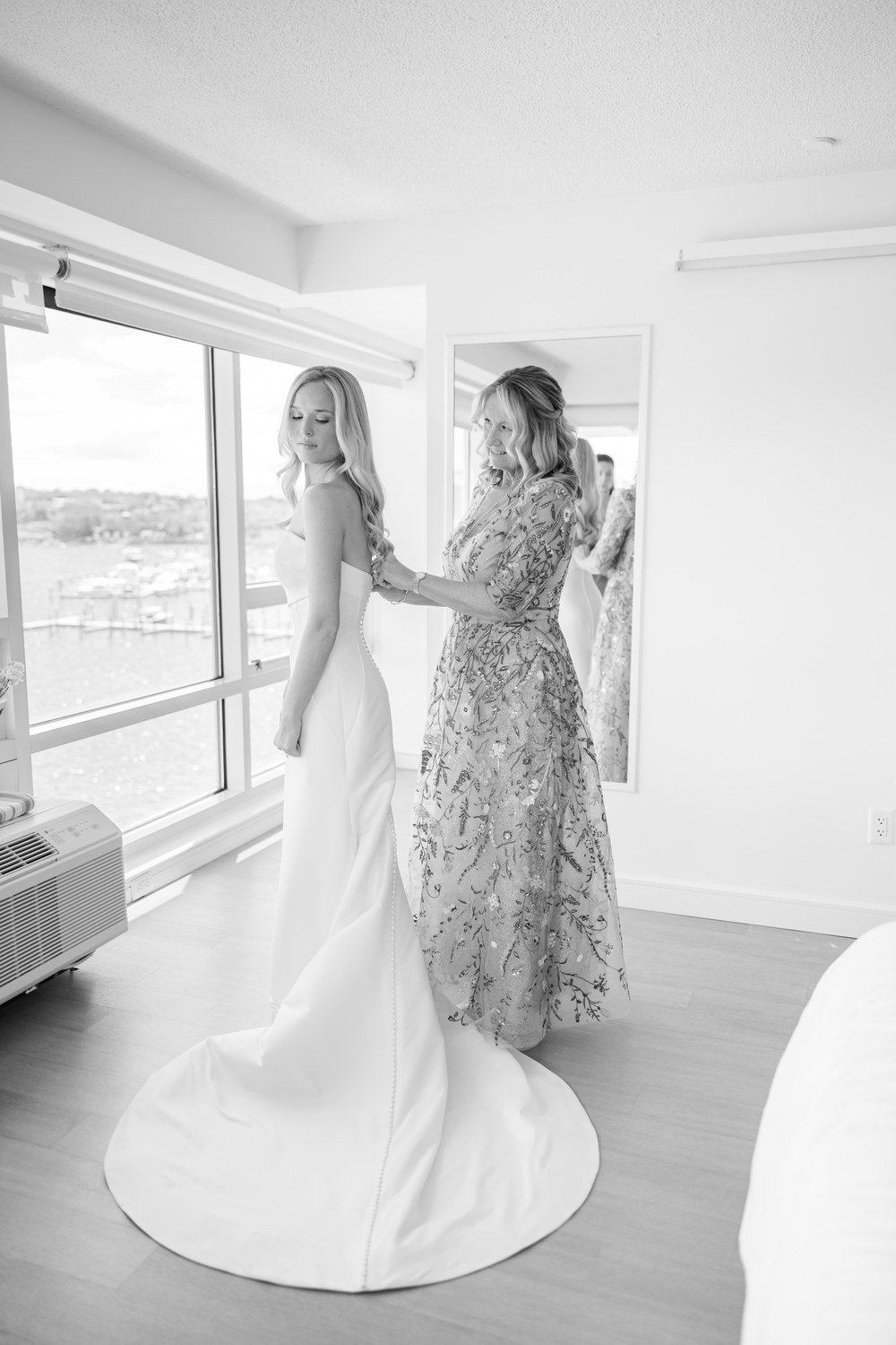 Black and white photo of the bride's mother helpin