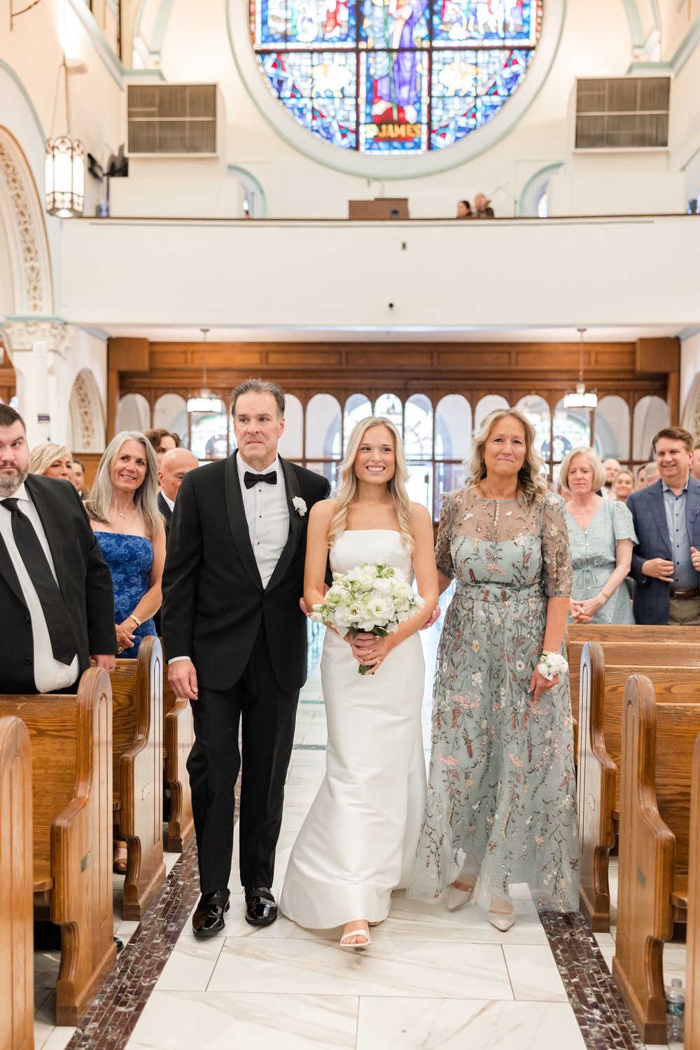 Bride walking down the aisle with her parents