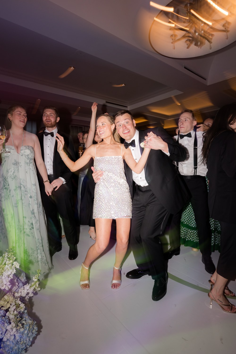 Bride and groom dancing with guests