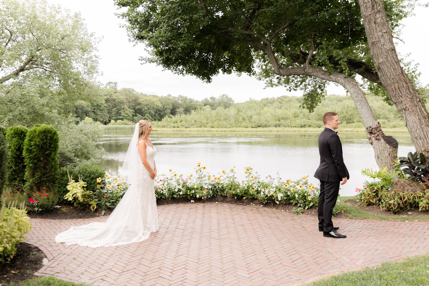 First look moment under a tree by the lake at The Mill Lakeside Manor