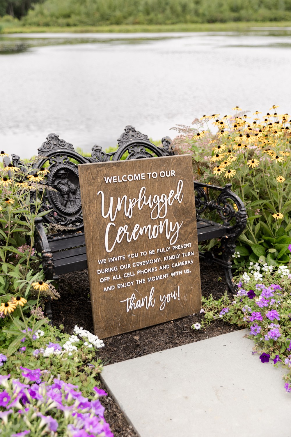 Unplugged ceremony sign in the garden at The Mill Lakeside Manor