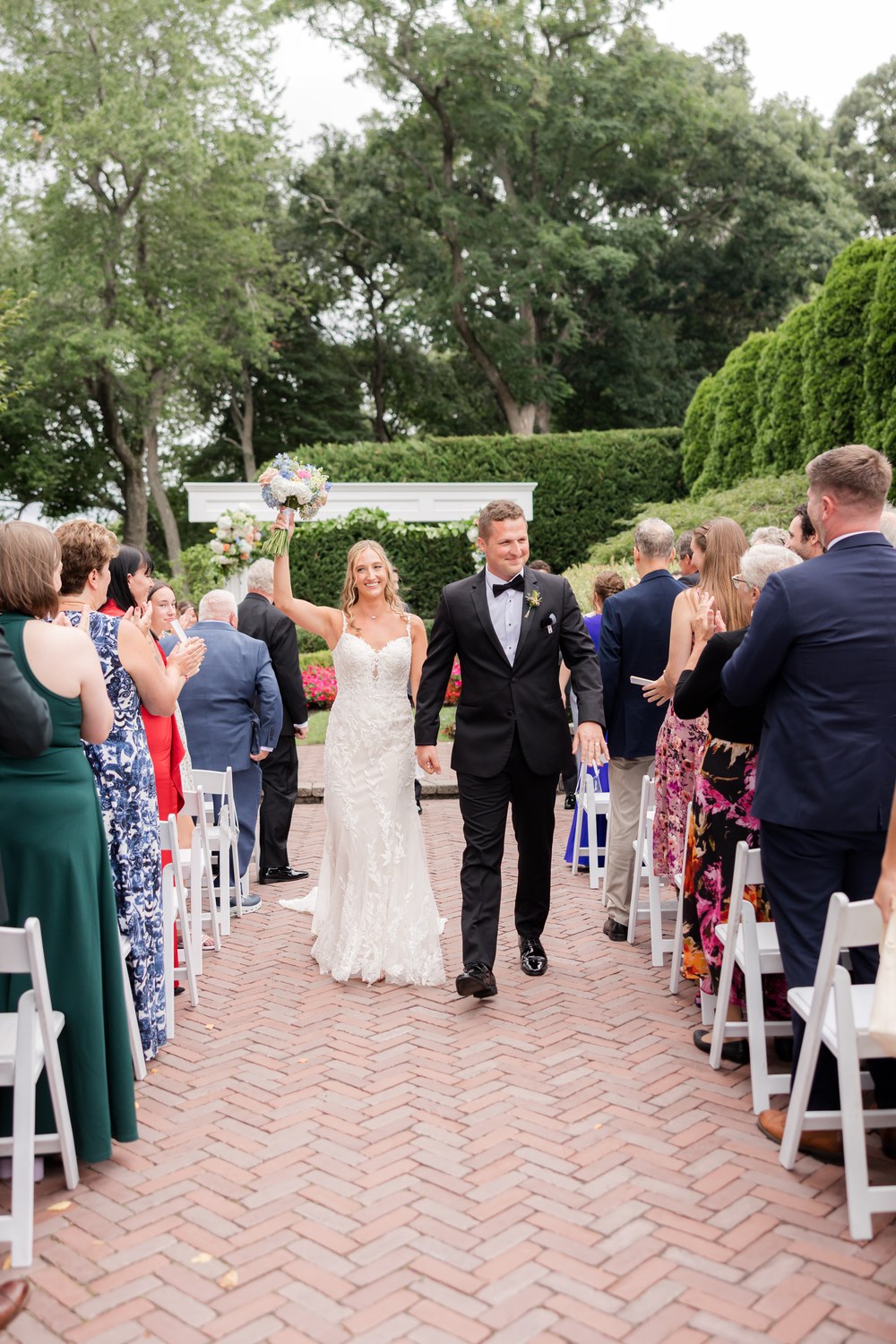 Newlyweds recessing down the aisle as guests applaud