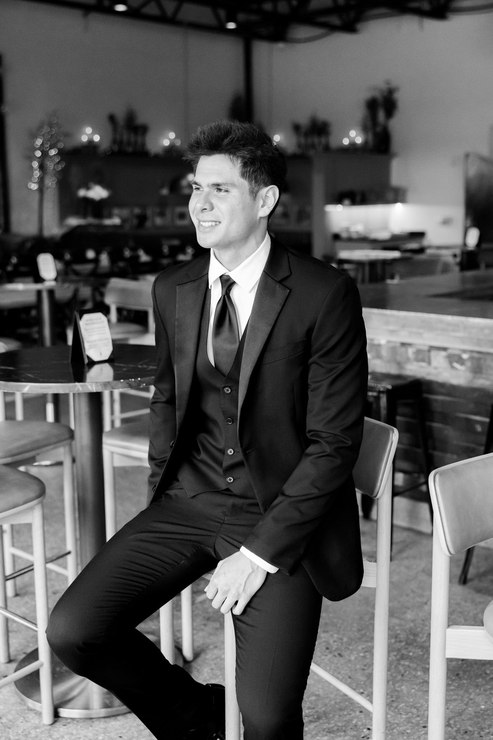 Black and white portrait of the groom getting ready
