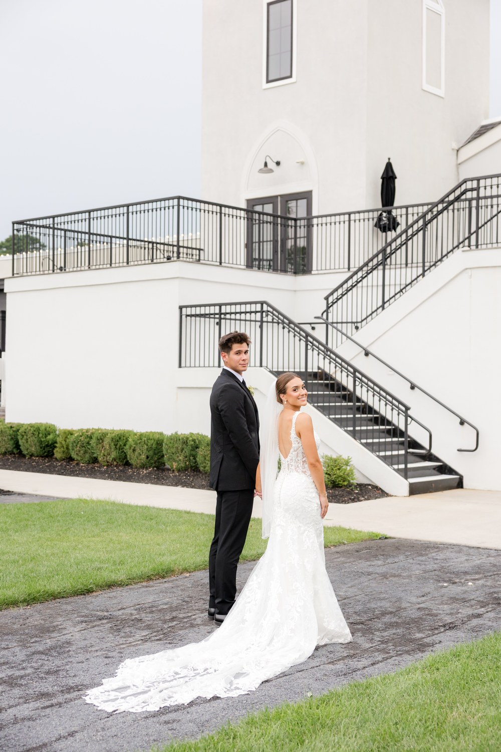 The bride and groom in front of the Renault Winery estate building