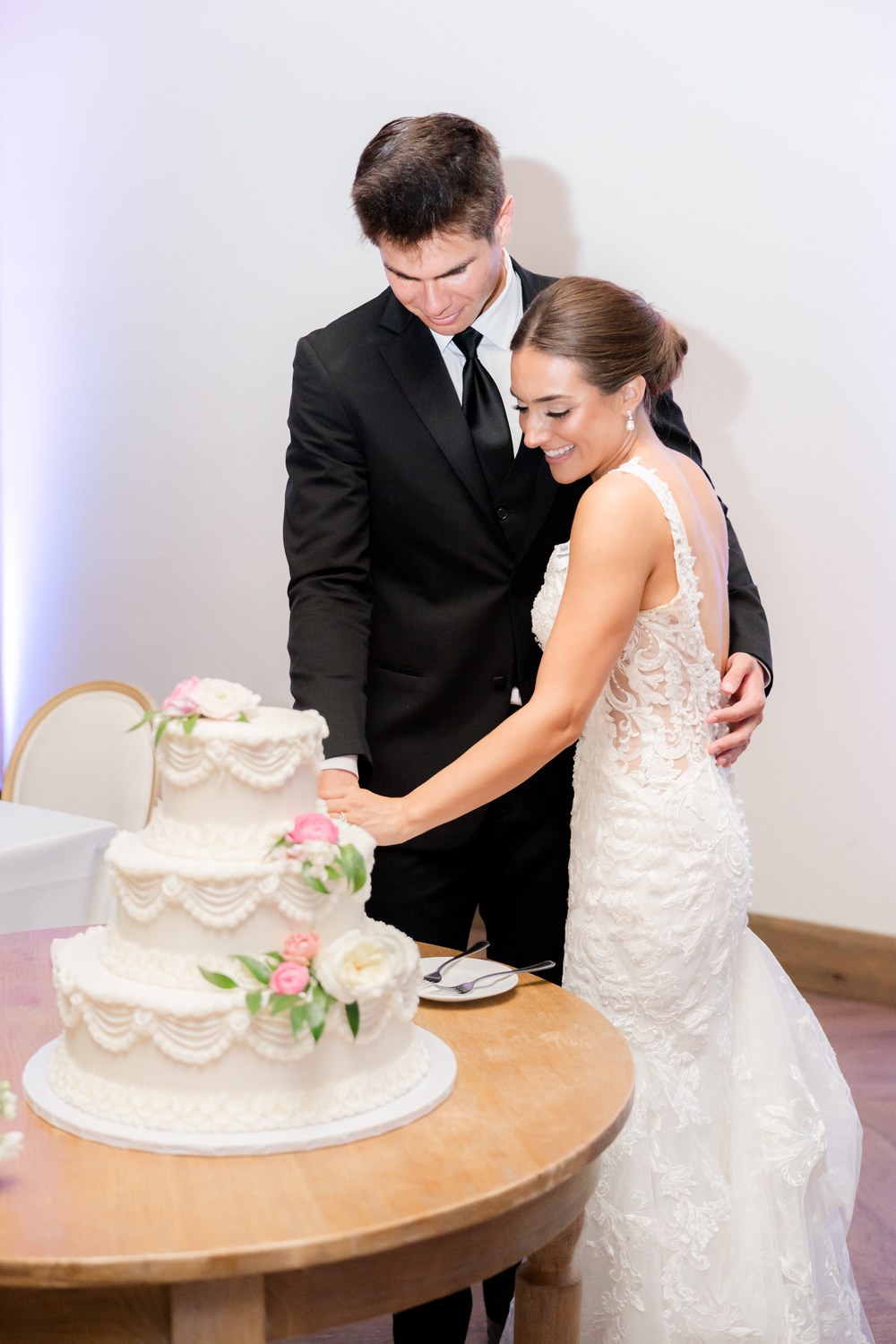 The bride and groom cutting their wedding cake