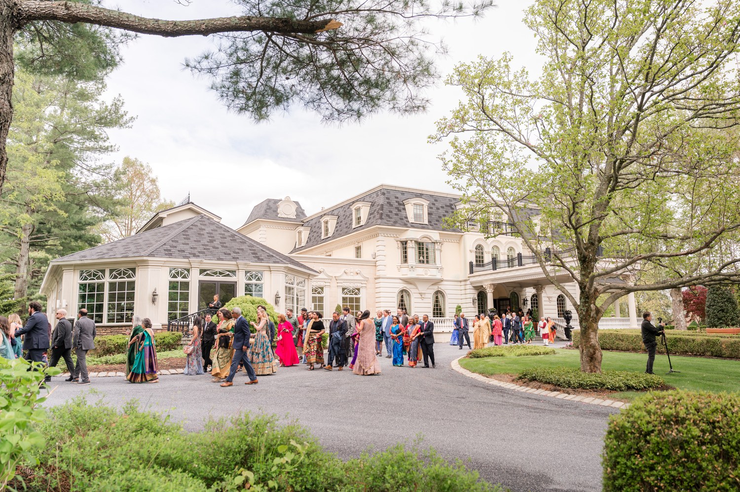 Wide view of baraat crowd gathering outside Ashford Estate