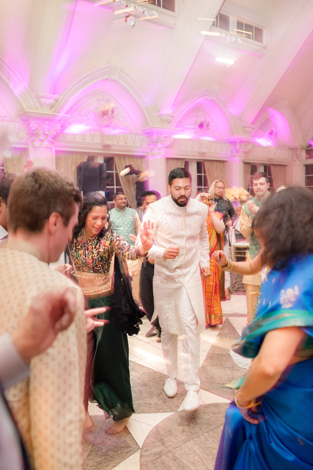 Bride and groom dancing together surrounded by cheering guests at Ashford Estate